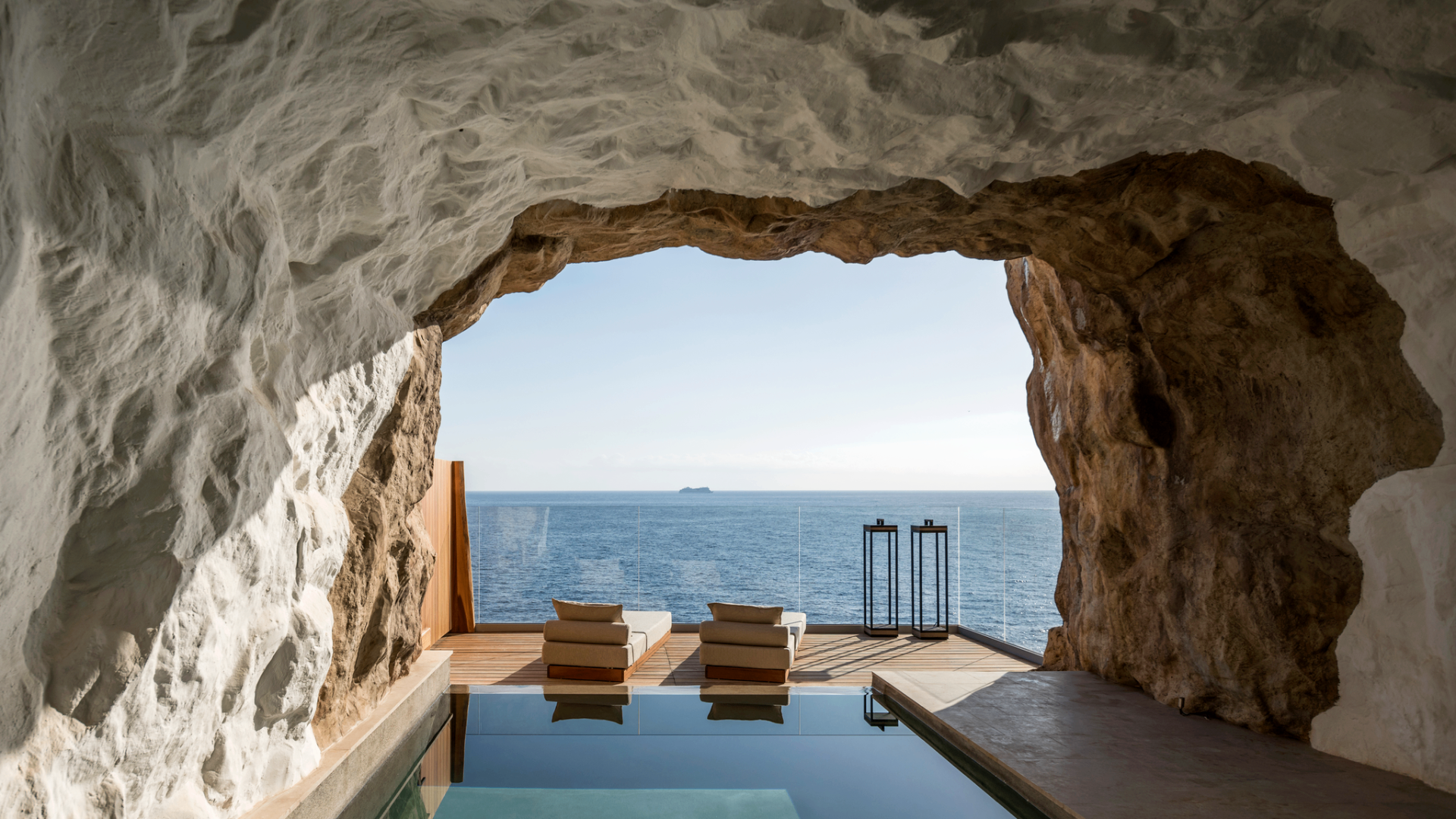 Ibiza cliffside cave opening to an infinity pool and the Mediterranean sea